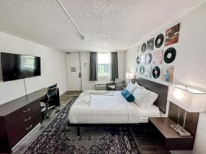 a hotel room with a bed and a television at Sleepover Nashville Studio Apartments in Nashville