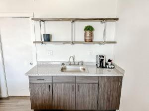 a kitchen counter with a sink in a room at Sleepover Nashville Studio Apartments in Nashville