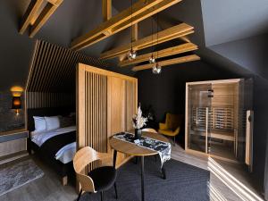 a bedroom with a bed and a table and chairs at TWIN prémium apartman in Tihany