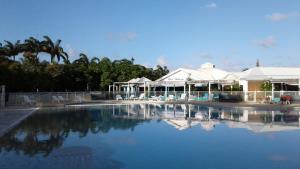 a large swimming pool in front of a resort at Joli Duplex à St Francois in Saint-François +28 photos
