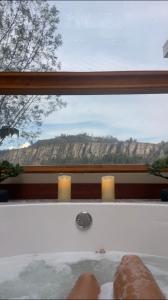 a window with two candles in a bath tub at Casa del Oro in Suesca