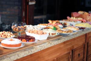 a buffet filled with different types of cakes and pastries at Park Hotel Modelo in Pinhalzinho