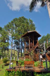 a playground with a wooden play structure with benches at Park Hotel Modelo in Pinhalzinho