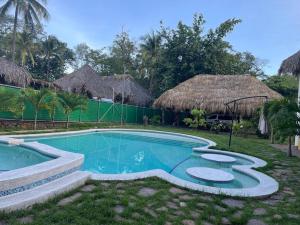 a swimming pool in front of a resort at RodMar Hotel in El Cuco