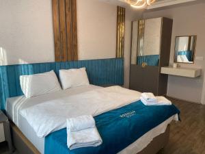 a bedroom with a large bed with towels on it at Rosella Royal Suit - روزيلا رويال in Trabzon