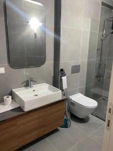 a bathroom with a sink and a toilet and a mirror at Rosella Royal Suit - روزيلا رويال in Trabzon +14 photos