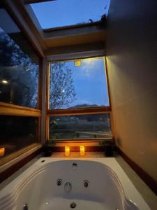 a bath tub in a bathroom with a window at Casa del Oro in Suesca
