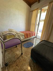 1 dormitorio con 2 camas en una habitación con ventana en Tres Lunas Alojamiento Individual, en Chuy