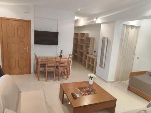 a living room with a couch and a table at Klio's apartment in Lavrio
