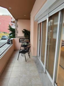 a balcony with a table and chairs on it at Klio's apartment in Lávrion