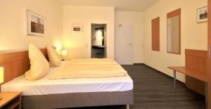 ein Schlafzimmer mit einem großen Bett in einem Zimmer in der Unterkunft Haller Hotel Garni in Monschau