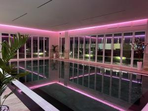 una piscina en un edificio con luces moradas en Top Villas Durres en Durrës