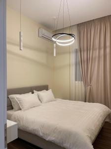 a bedroom with a large white bed with a window at Top Villas Durres in Durrës