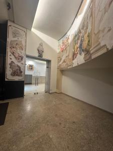 an empty room with paintings on the walls at DATRI Petite Suite 8 in Vienna