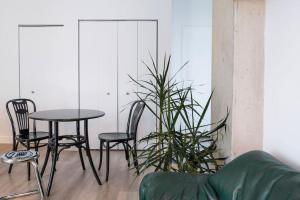 a table and chairs and a plant in a room at Stuning penthouse old montreal in Montreal