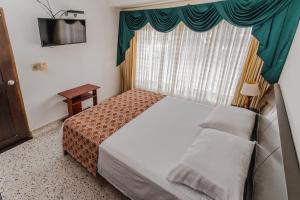 Postel nebo postele na pokoji v ubytování Casa Hotel Miriam