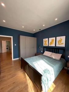 a bedroom with a large bed with blue walls at Stylish living in Downtown UB in Ulaanbaatar