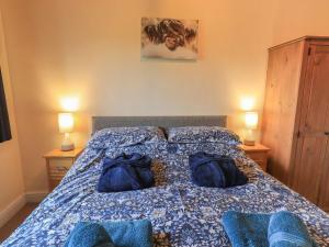 Katil atau katil-katil dalam bilik di Speight Cottage