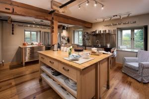 a kitchen with a large island in the middle at Heiton Mill House in Kelso
