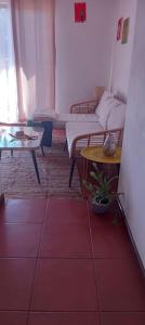 a living room with a couch and a table at Millacohouse in Pichilemu