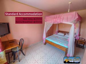 a small bedroom with a bunk bed and a desk at Sunciti Resort Sagana 