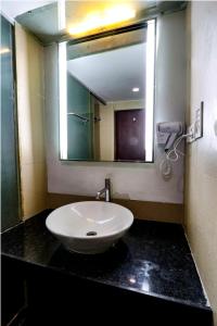 a bathroom with a sink and a mirror at Hotel Care Holiday Banjara- a Luxury Collection Hotel- An Svm Hotel in Hyderabad