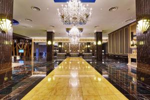 a hallway of a hotel with a chandelier at The Park Front Hotel at Universal Studios Japan in Osaka