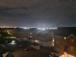 a view of a city at night with buildings at Impeccable 1-Bed Apartment in Purfleet in Purfleet