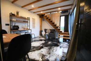a living room with a marble floor with a staircase at Natura Bungalow in Ždrelo