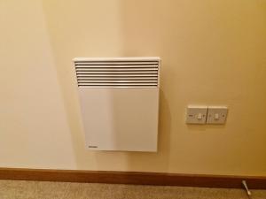 a room with a white radiator on a wall at Impeccable 1-Bed Apartment in Purfleet in Purfleet