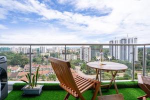 a balcony with a table and chairs and a view of a city at High Rise Haven: Panoramic Views in Nairobi