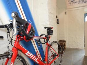 a red bike parked next to a wall at 3 Bed in Bude 57739 in Morwenstow