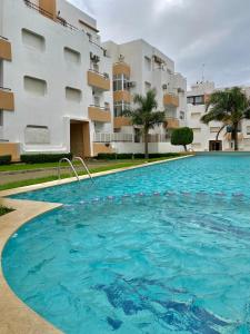 a large swimming pool in front of a building at Appartements résidence rivaldi Family Only in Tangier