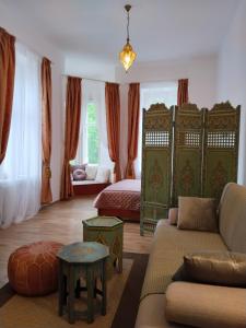 a living room with a bed and a couch at Leier apartments in Piešťany