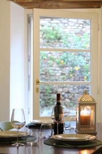 a table with a candle and glasses and a window at Borgo dei vigneti in Montecarlo