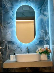 a bathroom with a sink and a mirror at Sea Pearl Luxury Rooms in La Spezia