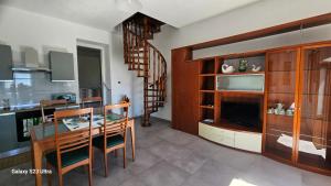 a kitchen and dining room with a table and chairs at Galbanera turismo in Albavilla +43 photos