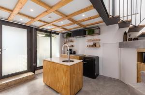 a kitchen with a sink and a large window at Urban Loft in Porto