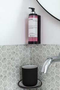 a bottle of soap sitting on top of a sink at Urban Loft in Porto +27 photos