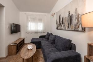 a living room with a couch and a table at Olive Grove in Bar