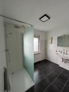 a large bathroom with a shower and a sink at MR Ferienwohnung - Wohnung Mary in Barsinghausen