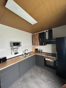 a kitchen with a sink and a counter top at MR Ferienwohnung - Wohnung Mary in Barsinghausen