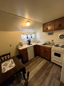 a small kitchen with a table and a stove at Beau Rivage Motel in Old Orchard Beach