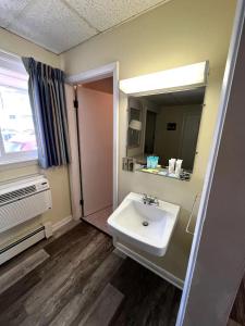 a bathroom with a sink and a mirror at Beau Rivage Motel in Old Orchard Beach