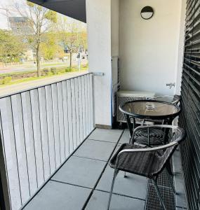 a balcony with a table and chairs and a window at Brand New Apartment, Top Location-Near VIC/Danube in Vienna