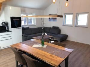 a living room with a table and a couch at Zweizimmer-Apartment in Buchenberg +14 photos