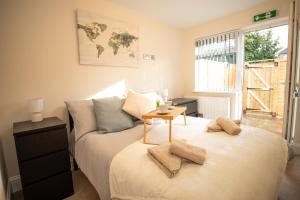 a bedroom with a bed with a table on it at Quite and comfortable Eastbourne in Eastbourne