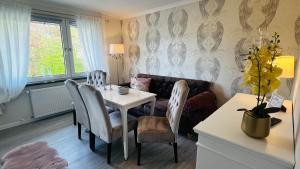 a dining room with a table and chairs at Maison Lily Apartment 5 in Bad Lauterberg
