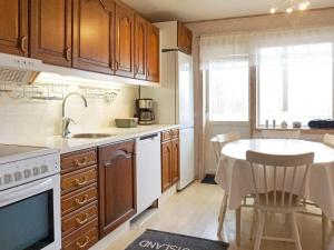 凱爾魯巴奇亞的住宿－Holiday home Fjällbacka VII，厨房配有木制橱柜、桌子和水槽。