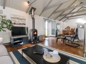 Una sala de estar con chimenea y televisión. en An Skyber, en Penzance